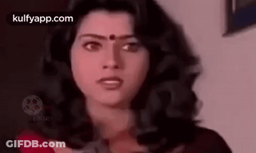 Woman With Long Dark Hair And Red Bindi Looking At Camera GIF