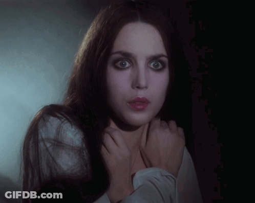 Woman With Long Dark Hair And White Shirt Hands On Neck GIF