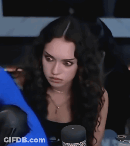 Woman With Long Dark Hair At Microphone GIF