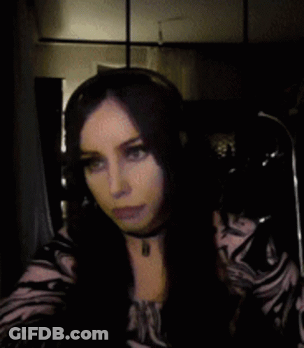 Woman With Long Dark Hair In Choker And Zebra Print Shirt GIF