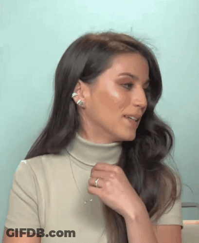 Woman With Long Dark Hair In Turtleneck And Necklace GIF