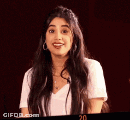Woman With Long Dark Hair In White Shirt And Earrings GIF
