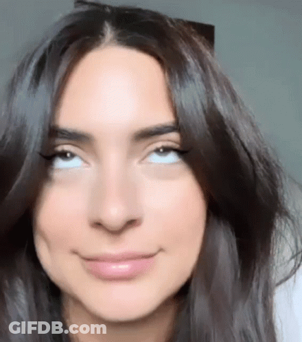 Woman With Long Dark Hair Making Face GIF