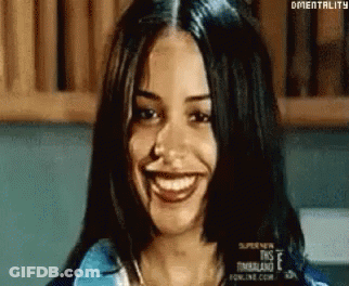 Woman With Long Dark Hair Smiling At Camera GIF