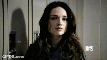 Woman With Long Dark Hair Standing In Front Of Locker GIF
