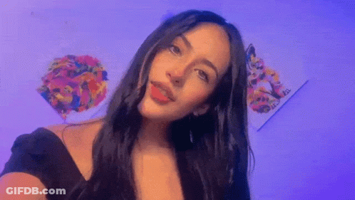 Woman With Long Dark Hair Taking Selfie At Painting GIF