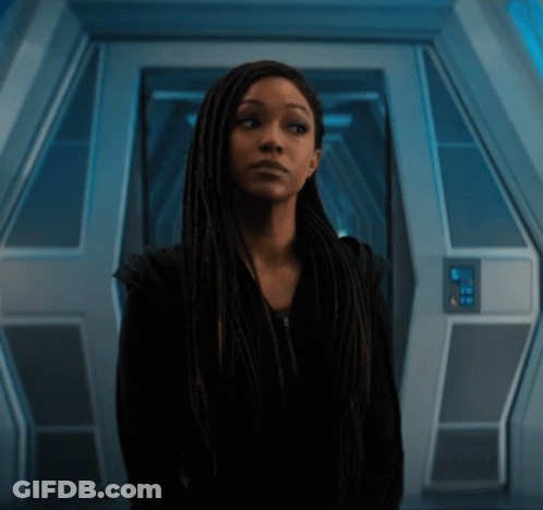 Woman With Long Dreadlocks In Dark Room GIF