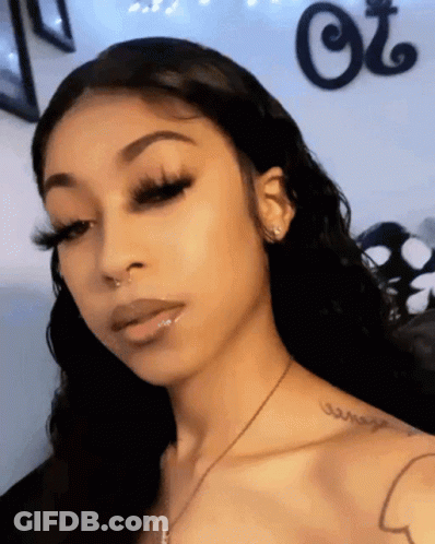 Woman With Long Eyelashes And Shoulder Tattoo GIF