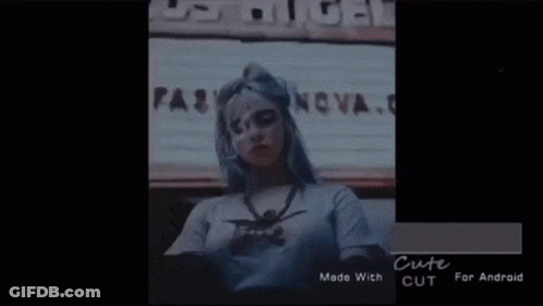 Woman With Long Gray Hair In White And Red Jacket GIF