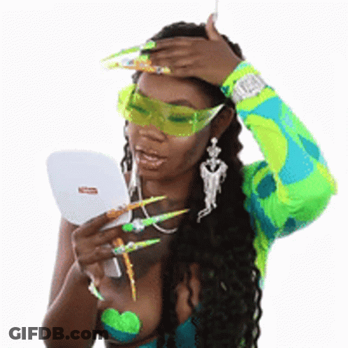 Woman With Long Green Nails Looking In Mirror GIF