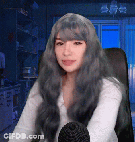 Woman With Long Grey Hair Sitting In Chair GIF
