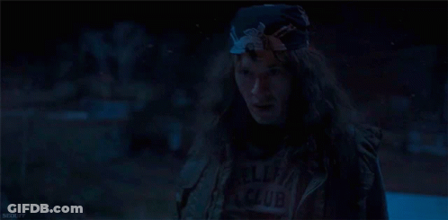 Woman With Long Hair And Bandana In Dark Room GIF