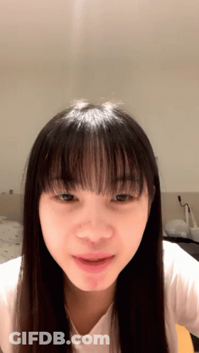 Woman With Long Hair And Bangs Close Up GIF