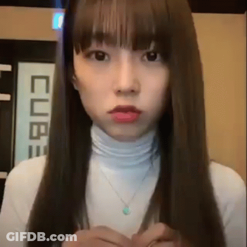 Woman With Long Hair And Bangs In White Turtleneck And Necklace GIF
