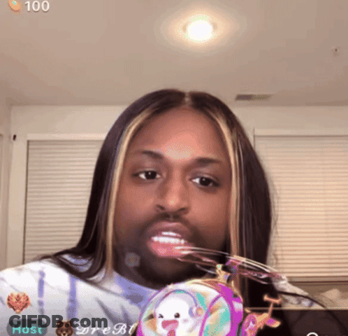 Woman With Long Hair And Beard Holding Purse Saying Host GIF