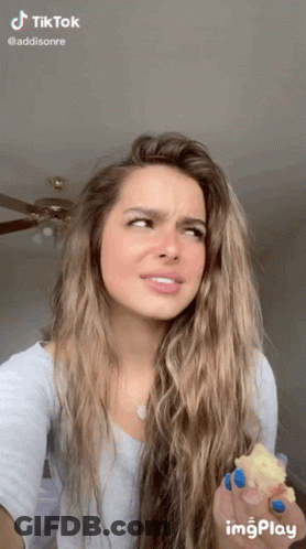 Woman With Long Hair And Blue Nail Polish Holding Food GIF