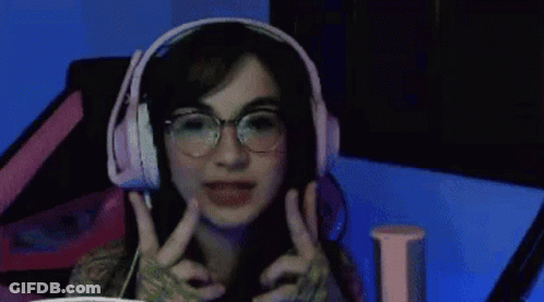 Woman With Long Hair And Necklace Making Funny Face GIF