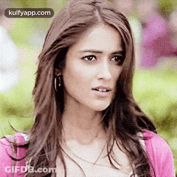 Woman With Long Hair And Pink Sweater Making Funny Face GIF