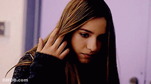 Woman With Long Hair Holding Hand To Head GIF