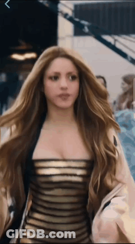 Woman With Long Hair In Black Gold Dress GIF