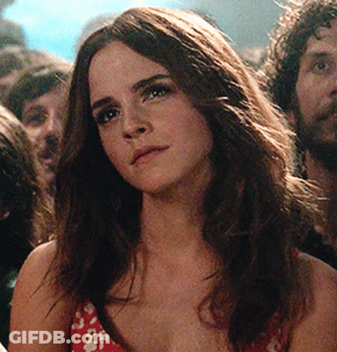 Woman With Long Hair In Crowd Looking At Camera GIF