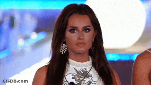 Woman With Long Hair In Earrings And White Top GIF
