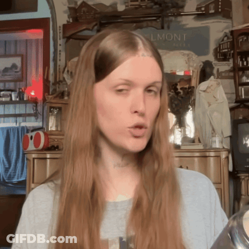 Woman With Long Hair In Front Of Belmont Sign GIF