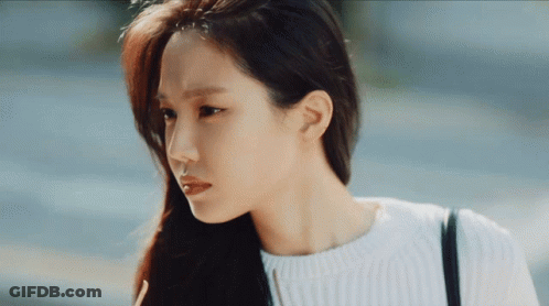 Woman With Long Hair In White Sweater And Black Bag GIF
