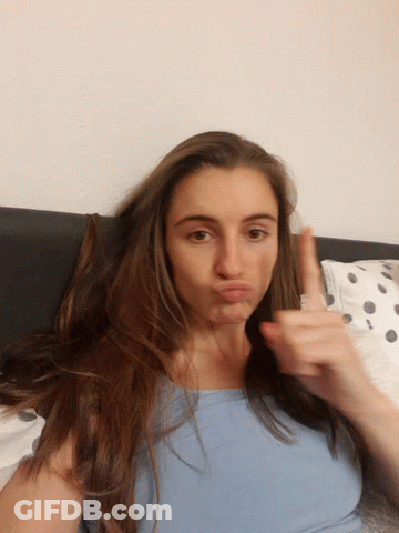 Woman With Long Hair Laying On Bed GIF