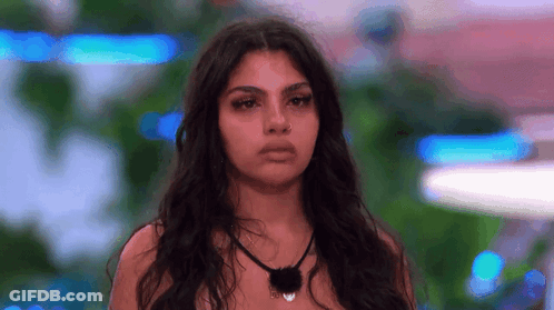 Woman With Long Hair Looking At Camera GIF