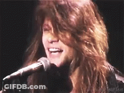 Woman With Long Hair Singing Into Microphone GIF