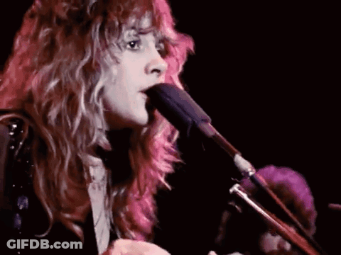 Woman With Long Hair Singing Into Microphone Playing Guitar GIF