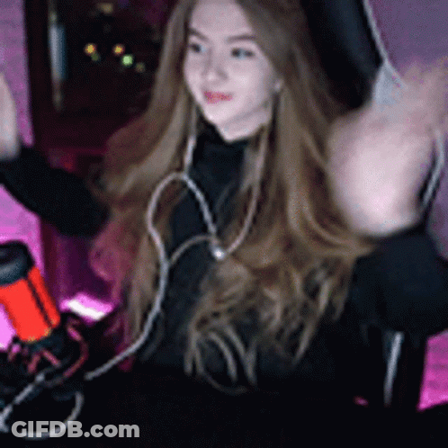 Woman With Long Hair Sitting At Microphone GIF