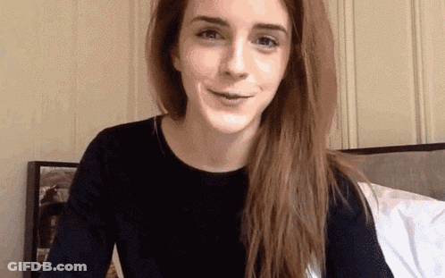 Woman With Long Hair Sitting On Bed GIF