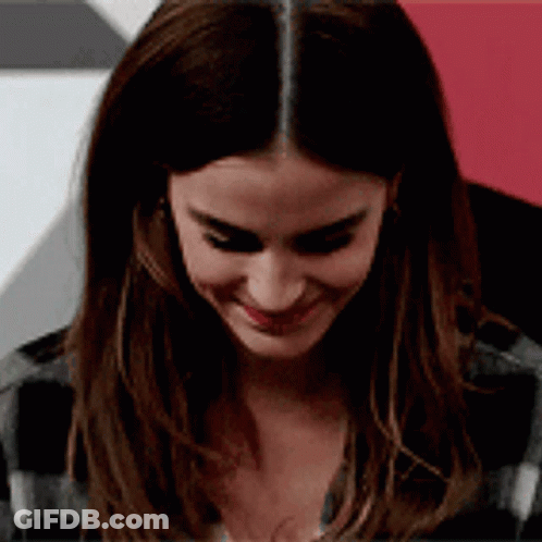Woman With Long Hair Smiling In Plaid Shirt GIF
