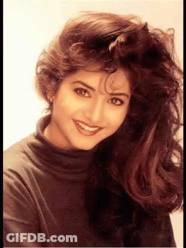 Woman With Long Hair Smiling In Turtleneck GIF