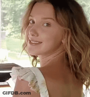 Woman With Long Hair Smiling Over Shoulder GIF