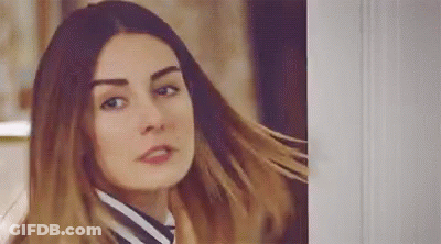 Woman With Long Hair Standing Next To Door GIF