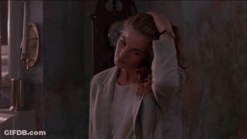 Woman With Long Red Hair And Earrings Looking Down GIF