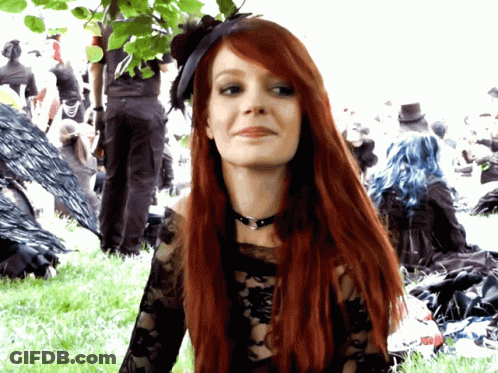 Woman With Long Red Hair In Black Top GIF