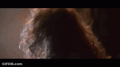 Woman With Long Red Hair In Dark Room GIF