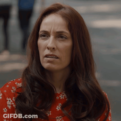 Woman With Long Red Hair In Red Floral Shirt GIF