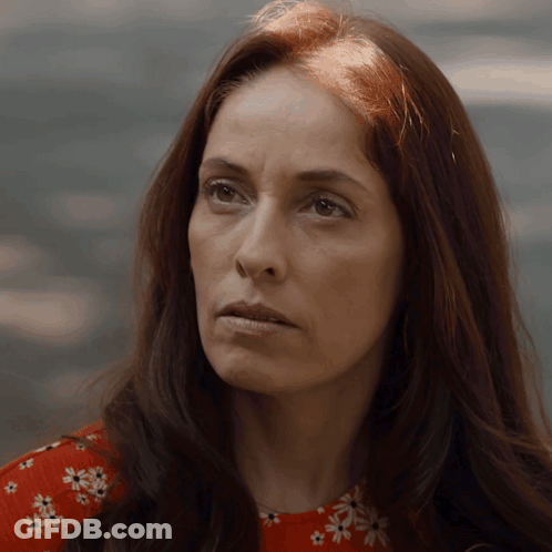 Woman With Long Red Hair In Red Floral Top GIF