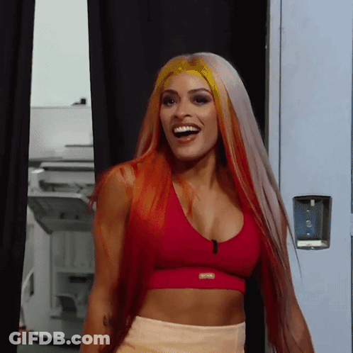 Woman With Long Red Hair In Red Sports Bra Smiling GIF