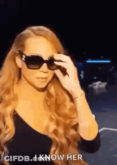 Woman With Long Red Hair In Sunglasses And Black Top GIF