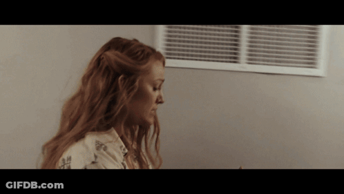 Woman With Long Red Hair Looking Down GIF