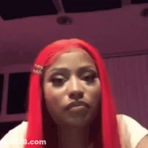 Woman With Long Red Hair Making Funny Face In White Shirt GIF