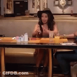 Woman With Long Red Hair Sitting In Chair Hands Outstretched GIF