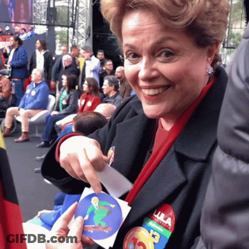 Woman With Lula Sticker On Jacket Smiling GIF