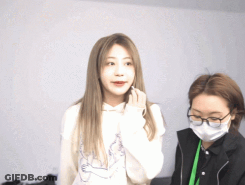 Woman With Mask And Glasses Next To Woman In Hoodie GIF
